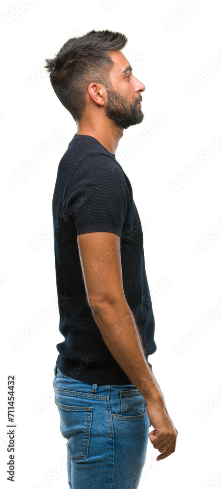 Adult hispanic man over isolated background looking to side, relax profile pose with natural face with confident smile. Adult hispanic man over isolated background looking to side, relax profile pose with natural face with confident smile.