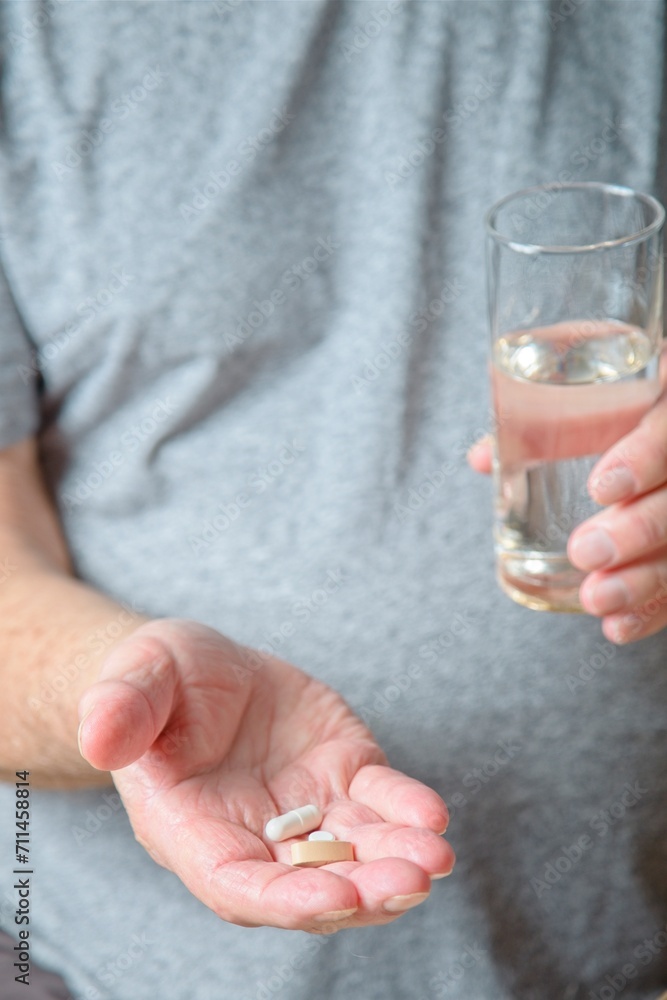 Close up of senior man holding medication in his hand Close up of senior man holding medication in his hand