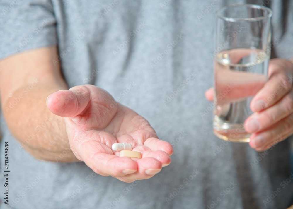 Close up of senior man holding medication in his hand Close up of senior man holding medication in his hand