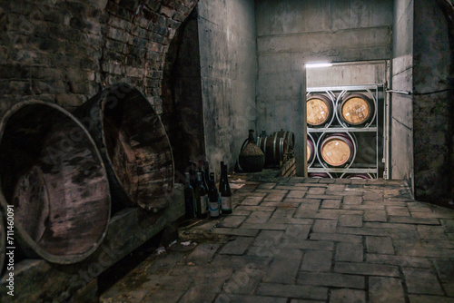 Traditional wine cellars with barrels, casks and stainless steel wine tanks