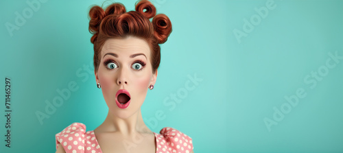 Woman with red lips surprise.Beautiful girl with curly hair surprised and shocked looks on you . Presenting your product. Portrait of impressed pretty person open mouth look camera news information  photo