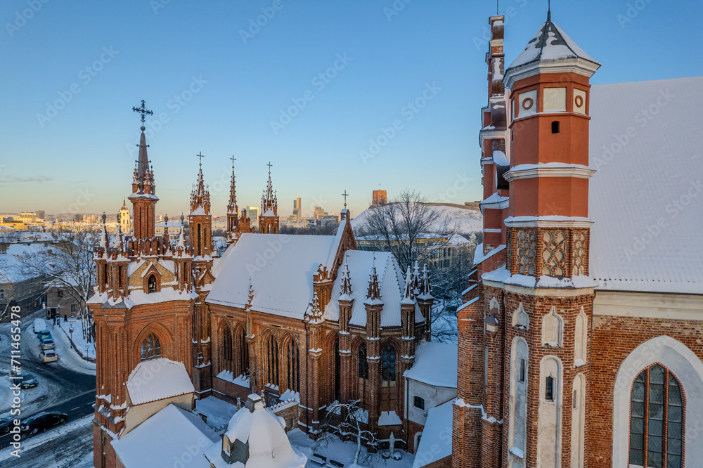 Fototapeta premium Aerial beautiful winter snowy sunrise view of Vilnius old town, St. Anne's Church (Vilniaus Šv. Onos bažnyčia), Lithuania