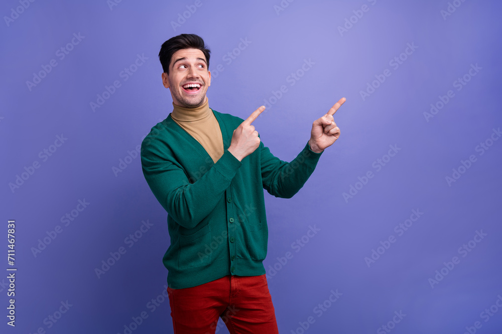 Photo of excited cheerful man wear stylish clothes demonstrate empty space black friday proposition isolated on purple color background Photo of excited cheerful man wear stylish clothes demonstrate empty space black friday proposition isolated on purple color background
