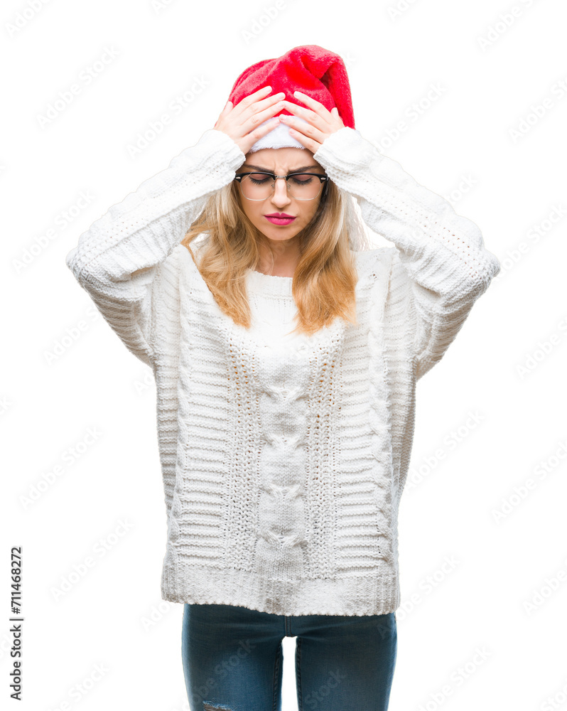 Young beautiful blonde woman wearing christmas hat over isolated background suffering from headache desperate and stressed because pain and migraine. Hands on head. Young beautiful blonde woman wearing christmas hat over isolated background suffering from headache desperate and stressed because pain and migraine. Hands on head.