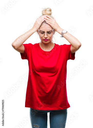 Young beautiful blonde woman wearing red t-shirt and glasses over isolated background suffering from headache desperate and stressed because pain and migraine. Hands on head.