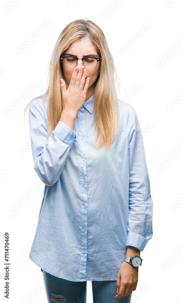 Young beautiful blonde business woman wearing glasses over isolated background bored yawning tired covering mouth with hand. Restless and sleepiness. Young beautiful blonde business woman wearing glasses over isolated background bored yawning tired covering mouth with hand. Restless and sleepiness.