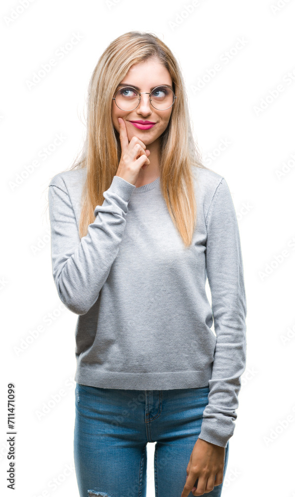 Young beautiful blonde woman wearing glasses over isolated background with hand on chin thinking about question, pensive expression. Smiling with thoughtful face. Doubt concept. Young beautiful blonde woman wearing glasses over isolated background with hand on chin thinking about question, pensive expression. Smiling with thoughtful face. Doubt concept.