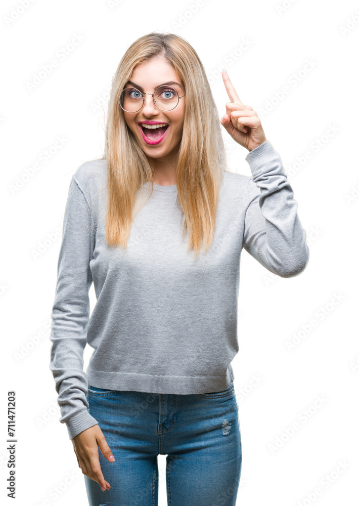 Young beautiful blonde woman wearing glasses over isolated background pointing finger up with successful idea. Exited and happy. Number one. Young beautiful blonde woman wearing glasses over isolated background pointing finger up with successful idea. Exited and happy. Number one.