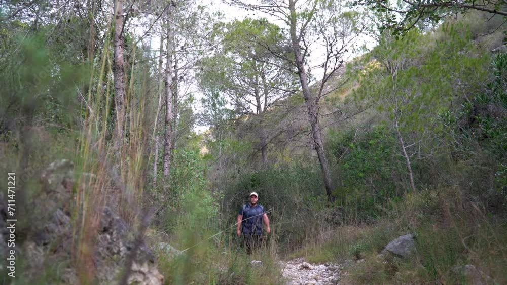 Overweight hiker man walks through the forest. Healthy lifestyle concept. Overweight hiker man walks through the forest. Healthy lifestyle concept.