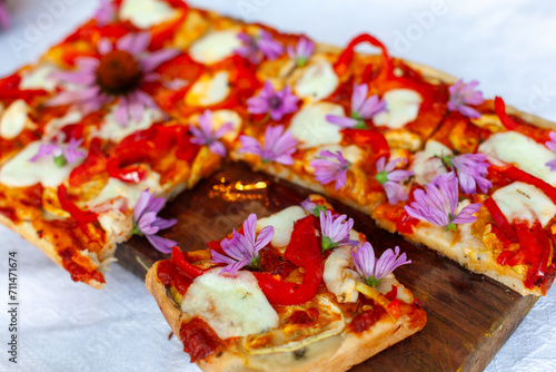 Vegetarian Home Made Gluten Free Rice Flour Pizza with Tomato Sauce Pepperoni Mozzarella and Edible Flowers