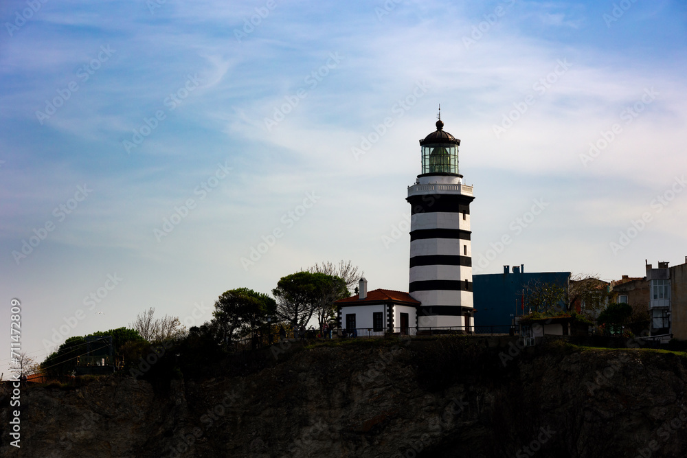 a lighthouse on the cliffs in a town.
