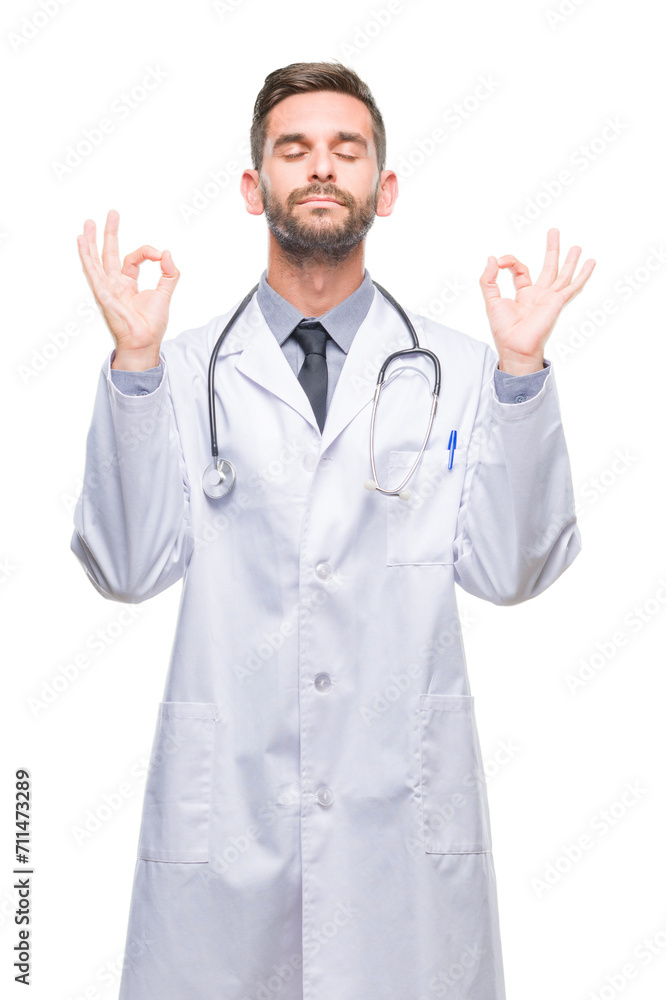 Young handsome doctor man over isolated background relax and smiling with eyes closed doing meditation gesture with fingers. Yoga concept.