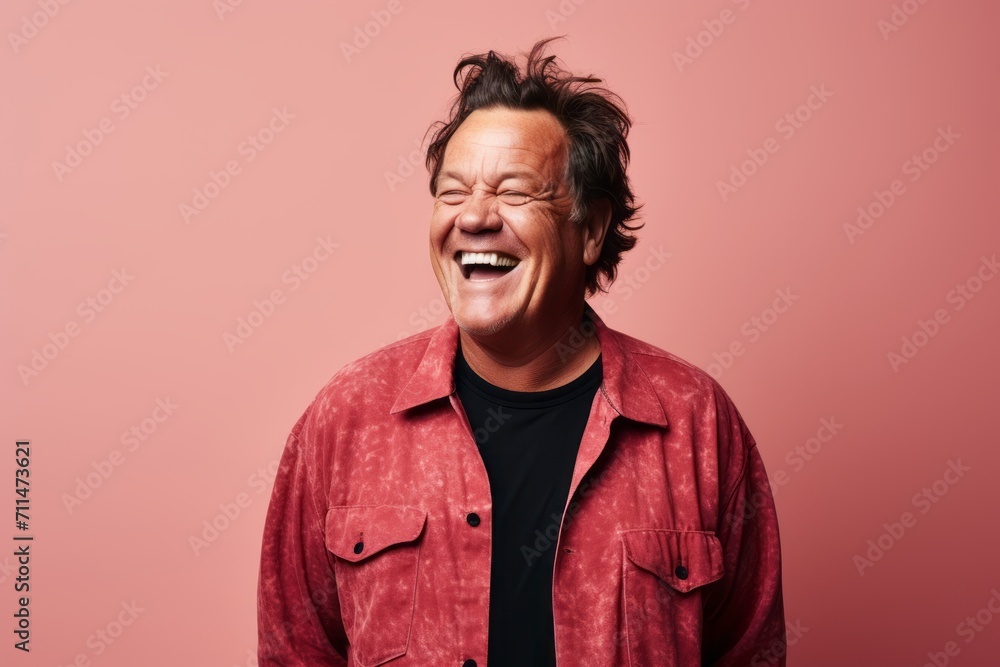 Portrait of a funny man laughing with closed eyes on a pink background Portrait of a funny man laughing with closed eyes on a pink background