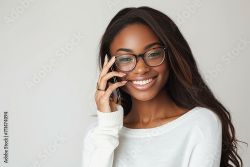 Portrait of happy black woman talking on mobile phone