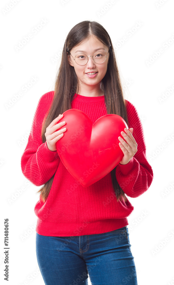 Young Chinese woman wearing graduate uniform red heart with a happy face standing and smiling with a confident smile showing teeth Young Chinese woman wearing graduate uniform red heart with a happy face standing and smiling with a confident smile showing teeth