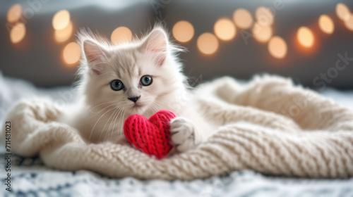 A fluffy Valentine's Day gift. Cute fluffy white kitten playing With Red Heart Valentine's card on white plaid. Valentine's card in the paws of a kitten. Valentines Day background. Generative Ai