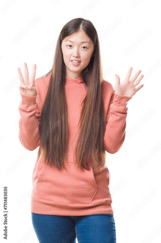 Young Chinese woman over isolated background wearing sport sweathshirt showing and pointing up with fingers number eight while smiling confident and happy. Young Chinese woman over isolated background wearing sport sweathshirt showing and pointing up with fingers number eight while smiling confident and happy.