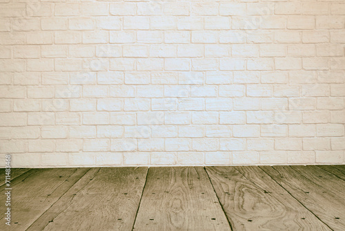 Empty room with beige brick wall and old wooden floor interior background © naiaekky