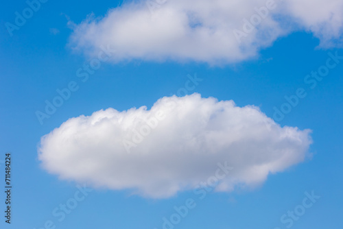 Beautiful white fluffy cloud floating in blue sky in sunny day, Cumulus are clouds which have flat bases and are often described as puffy, Horizon nature background with free copy space. © Sarawut