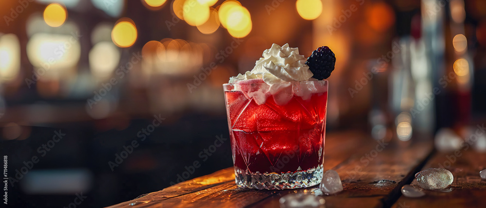Lovely ultra wide setting with a cocktail in glass, ice, whipped cream, blackberry, copy space