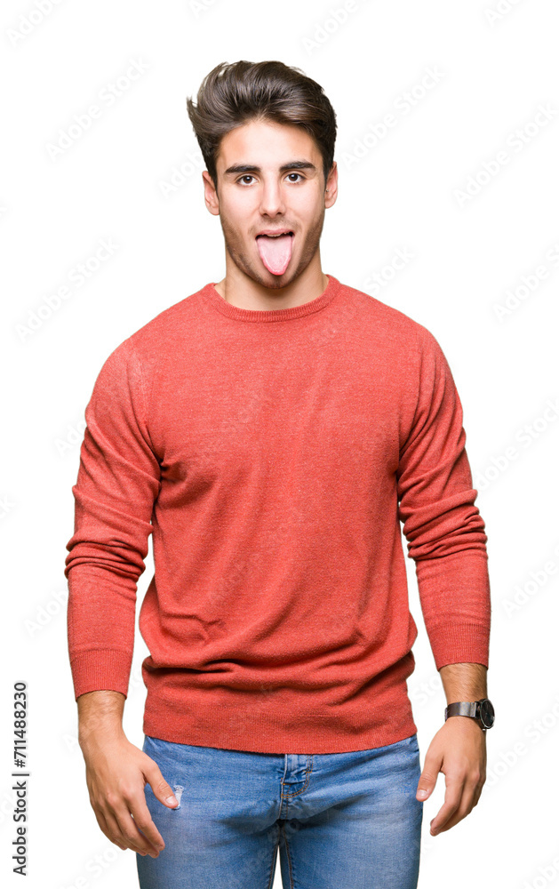 Fototapeta premium Young handsome man over isolated background sticking tongue out happy with funny expression. Emotion concept.