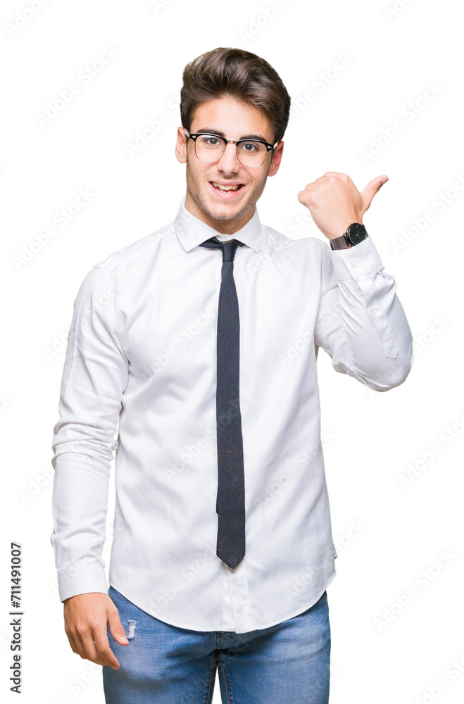 Young business man wearing glasses over isolated background smiling with happy face looking and pointing to the side with thumb up. Young business man wearing glasses over isolated background smiling with happy face looking and pointing to the side with thumb up.