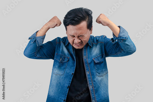 Young Asian Man with depressed expression with palms facing head. On isolated background