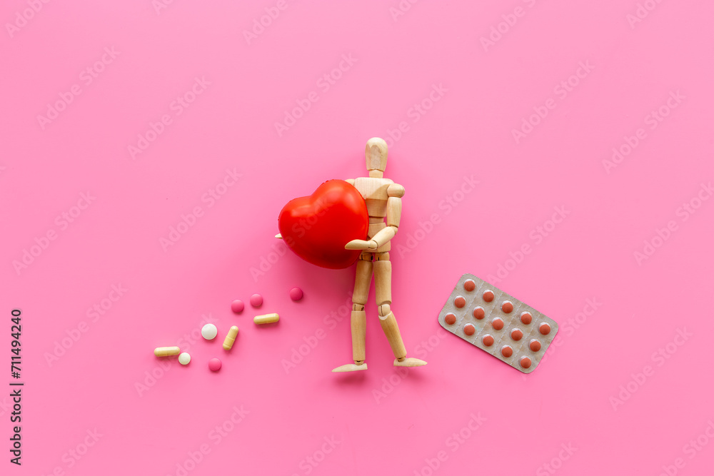 Wooden dummy man with heart. Medicine and healthcare concept. Heart diseases Wooden dummy man with heart. Medicine and healthcare concept. Heart diseases