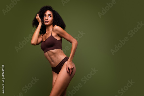 Studio no retouch photo of seductive dreamy lady dressed lingerie enjoying slim shape looking empty space isolated green color background