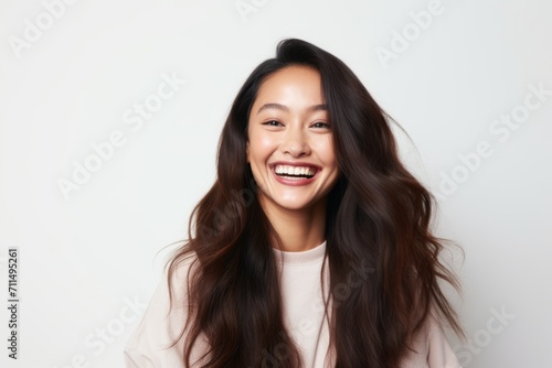 Portrait of a happy young asian woman with long hair, isolated on white background