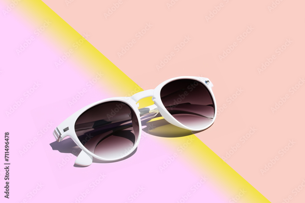 summer accessory. white women's sunglasses lie on a pink yellow gradient background close-up, creative concept summer accessory. white women's sunglasses lie on a pink yellow gradient background close-up, creative concept