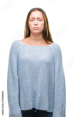 Young beautiful caucasian woman wearing winter sweater over isolated background skeptic and nervous, frowning upset because of problem. Negative person. © Krakenimages.com