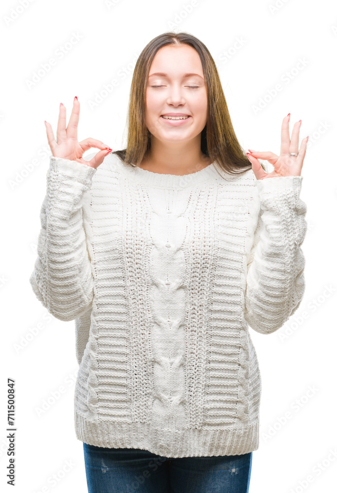 Young beautiful caucasian woman wearing winter sweater over isolated background relax and smiling with eyes closed doing meditation gesture with fingers. Yoga concept. Young beautiful caucasian woman wearing winter sweater over isolated background relax and smiling with eyes closed doing meditation gesture with fingers. Yoga concept.