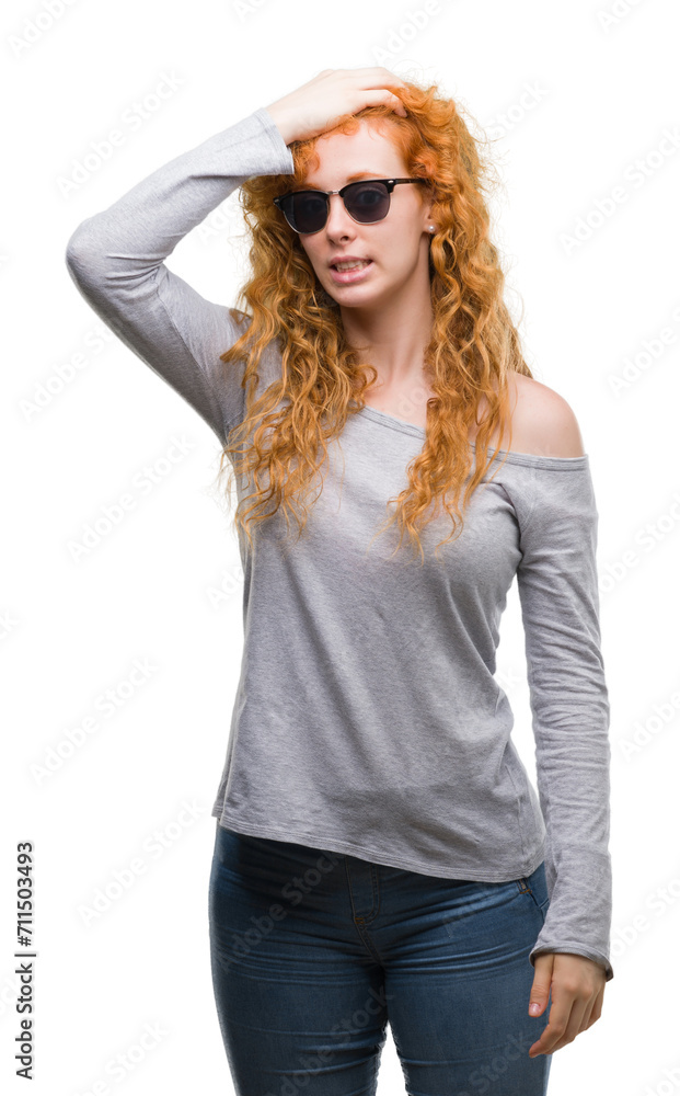 Young redhead woman wearing sunglasses stressed with hand on head, shocked with shame and surprise face, angry and frustrated. Fear and upset for mistake. Young redhead woman wearing sunglasses stressed with hand on head, shocked with shame and surprise face, angry and frustrated. Fear and upset for mistake.
