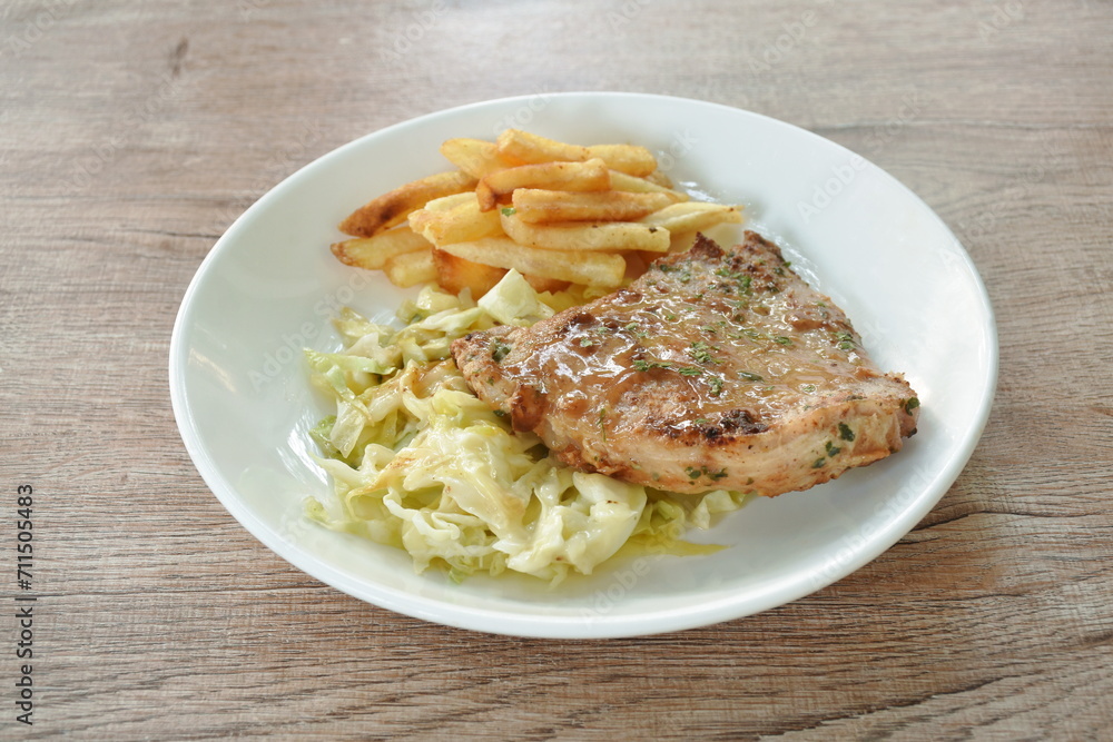 grilled pork steak with French fries and salad dressing mayonnaise in plate grilled pork steak with French fries and salad dressing mayonnaise in plate