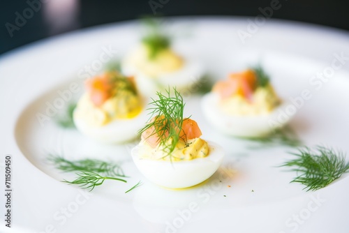 brightly lit deviled eggs with fresh dill garnish