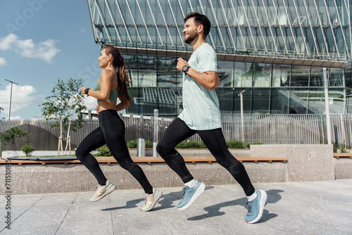 Energetic couple running together in an urban environment  showcasing a healthy  active lifestyle.