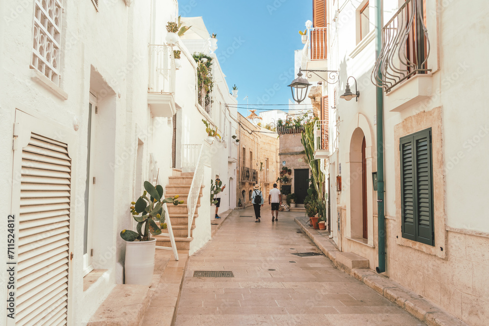Couple walking the streets of Monopoli in Puglia, Italy	
