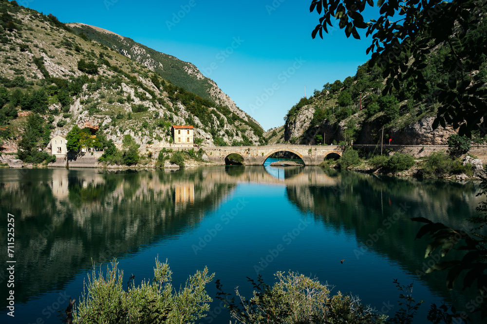 Beautiful calm lake with bridge - Lago di San Domenico near Scanno in Abruzzo, Italy