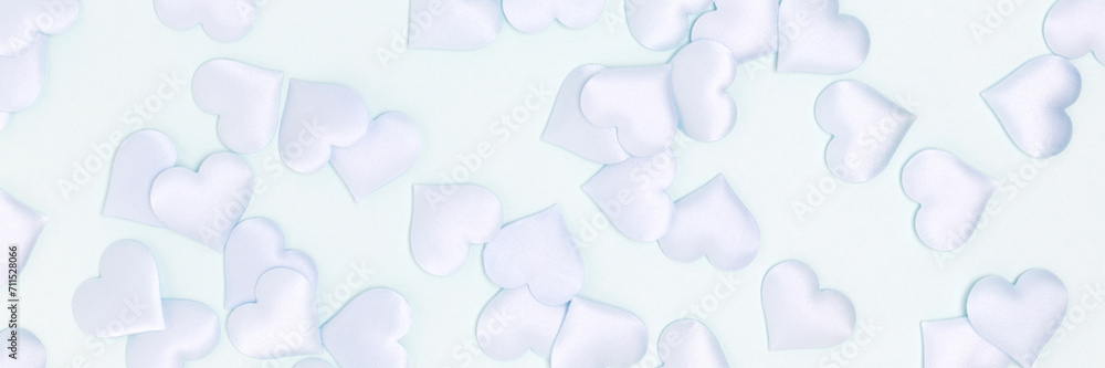 Fototapeta premium Banner with texture made of confetti in a heart shape on a blue background. Monochrome concept.