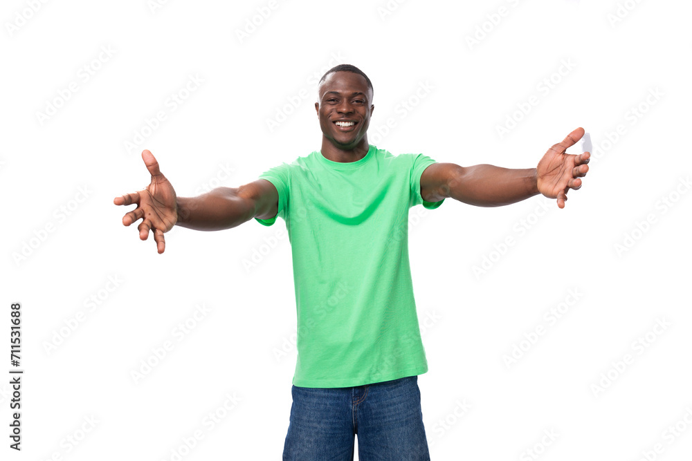 young positive american man in casual t-shirt rejoices on white background young positive american man in casual t-shirt rejoices on white background