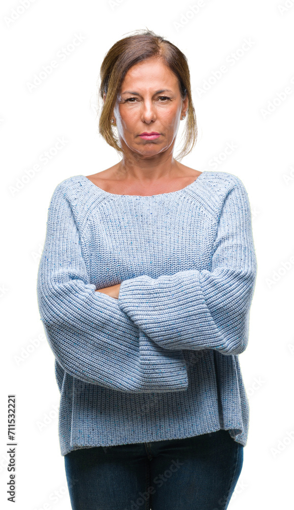 Middle age senior hispanic woman wearing winter sweater over isolated background skeptic and nervous, disapproving expression on face with crossed arms. Negative person. Middle age senior hispanic woman wearing winter sweater over isolated background skeptic and nervous, disapproving expression on face with crossed arms. Negative person.