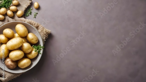 Bowl with potatoes and herbs on a gray background with cloth and potatoes. Potato cooking.