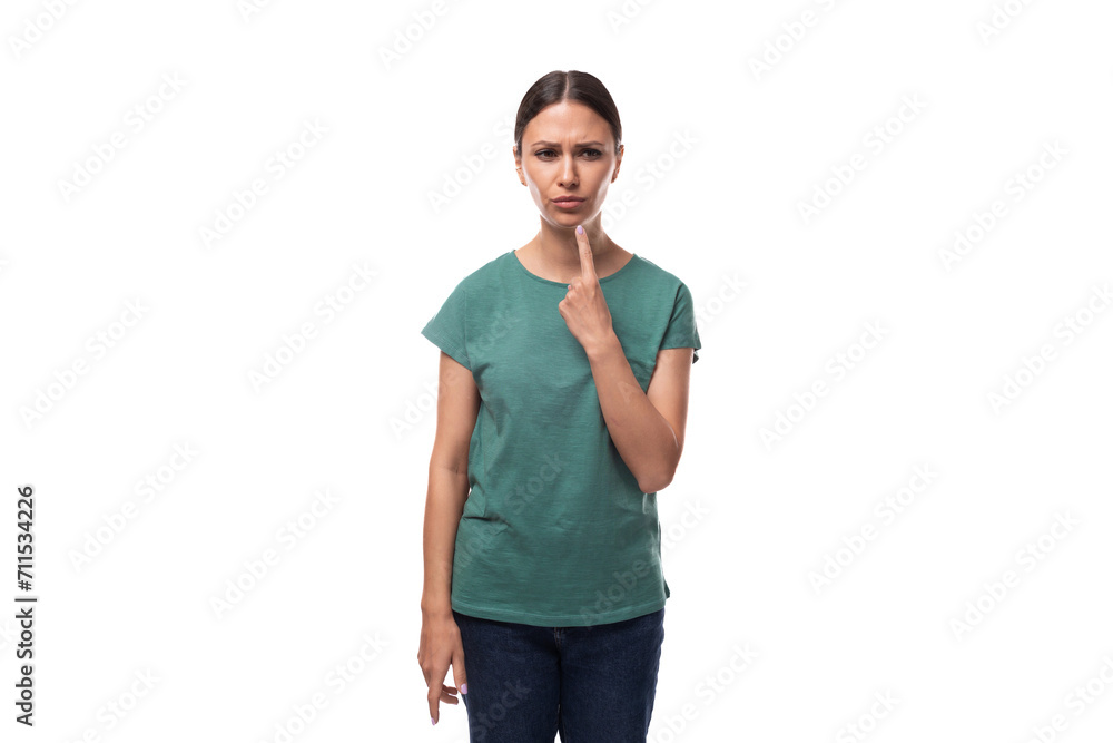 young brunette woman in a t-shirt rejoices thoughtfully looking at the camera young brunette woman in a t-shirt rejoices thoughtfully looking at the camera