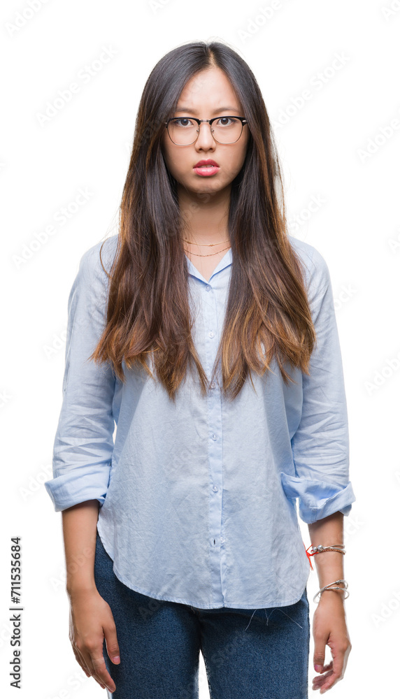 Young asian business woman wearing glasses over isolated background skeptic and nervous, frowning upset because of problem. Negative person. Young asian business woman wearing glasses over isolated background skeptic and nervous, frowning upset because of problem. Negative person.