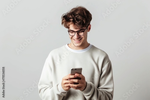 Young man using smartphone for calls and social media