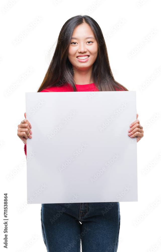 Young asian woman holding banner over isolated background with a happy face standing and smiling with a confident smile showing teeth Young asian woman holding banner over isolated background with a happy face standing and smiling with a confident smile showing teeth