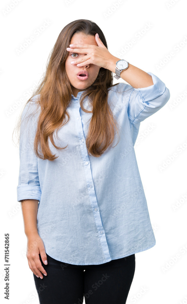 Young beautiful brunette business woman over isolated background peeking in shock covering face and eyes with hand, looking through fingers with embarrassed expression. Young beautiful brunette business woman over isolated background peeking in shock covering face and eyes with hand, looking through fingers with embarrassed expression.