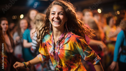 A girl in colorful clothes smiles in the crowd at a festival.