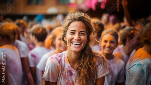 A girl smiles in the crowd at the Holi festival.
